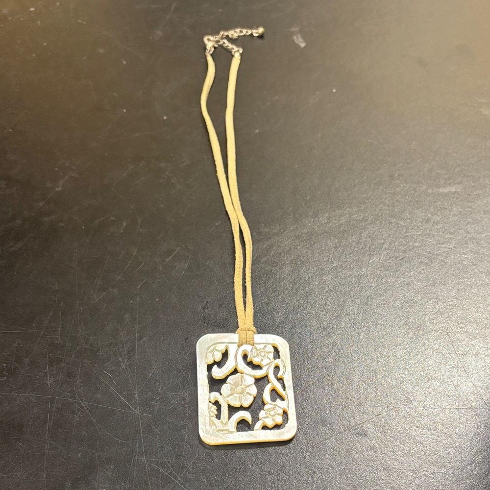 Carved Mother of Pearl Floral Pendant on a Suede Cord